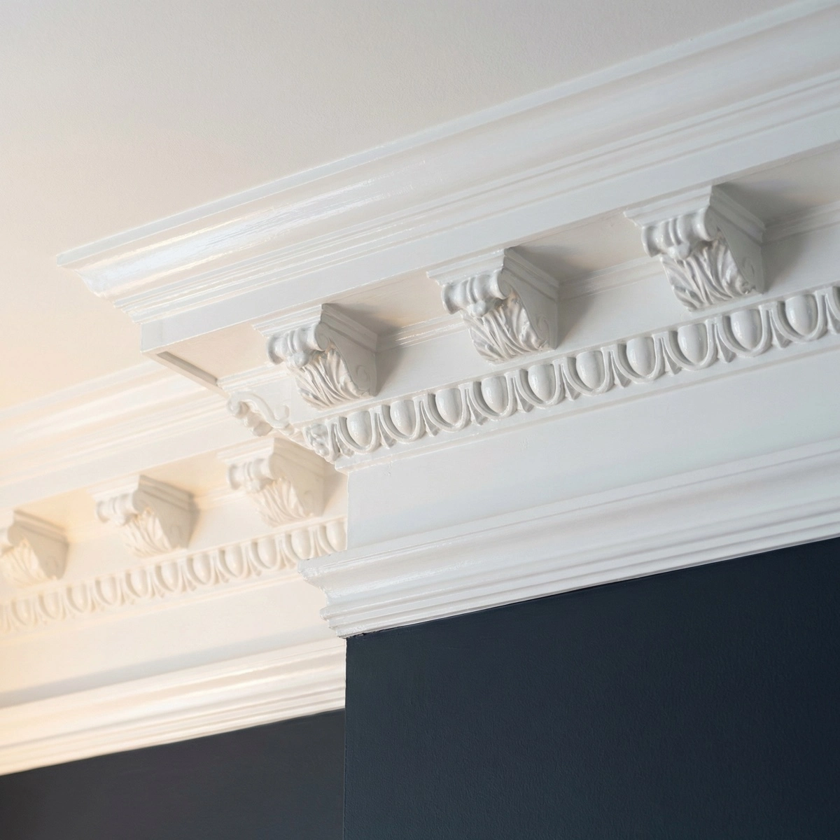 Freshly painted ornate original plaster crown molding in a Washington DC row house — semi-gloss